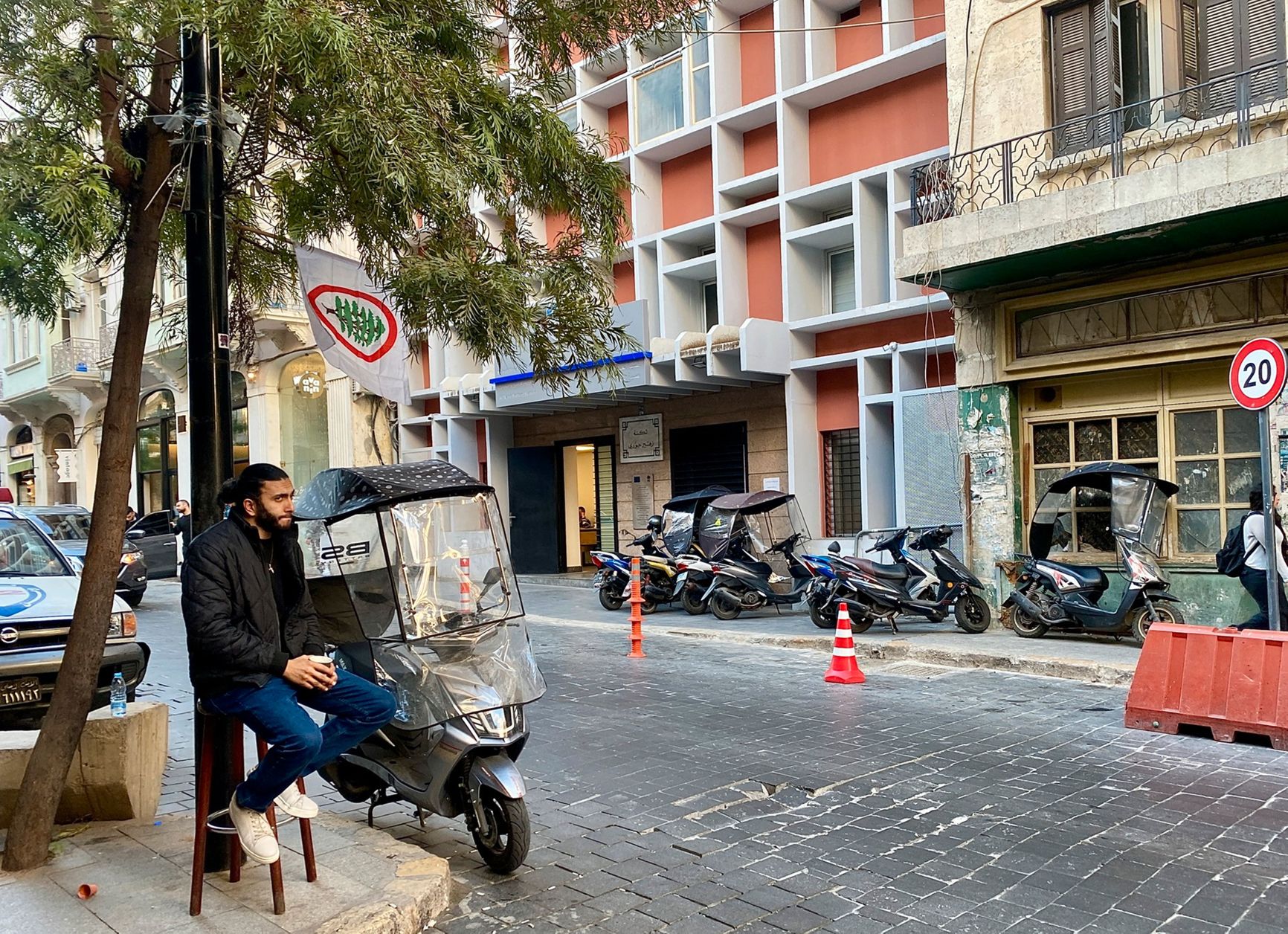 A Syrian refugee on Rue Armenia. Many of the Syrians fleeing the war travel on scooters with plastic windshields