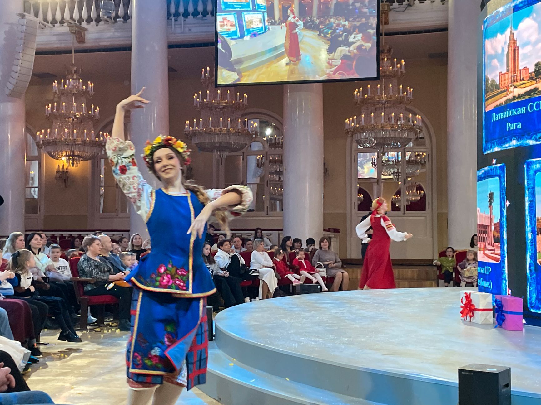 “The Ukrainian SSR with its capital in Kyiv!” — the announcer introduces the girl in the Ukrainian folk costume during the parade of former Soviet Socialist Republics.