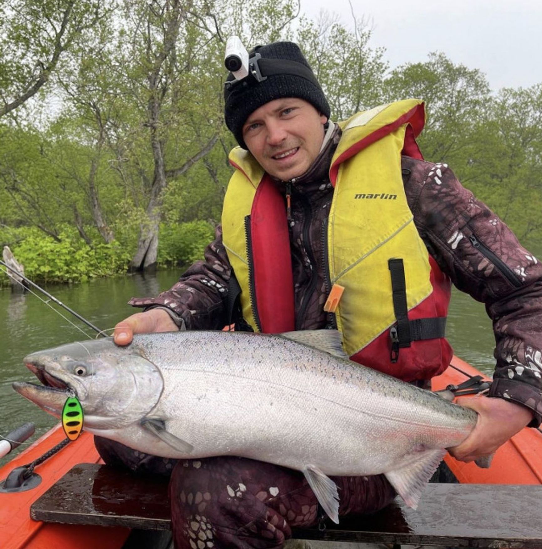 Fisherman with a chinook salmon in Kamchatka