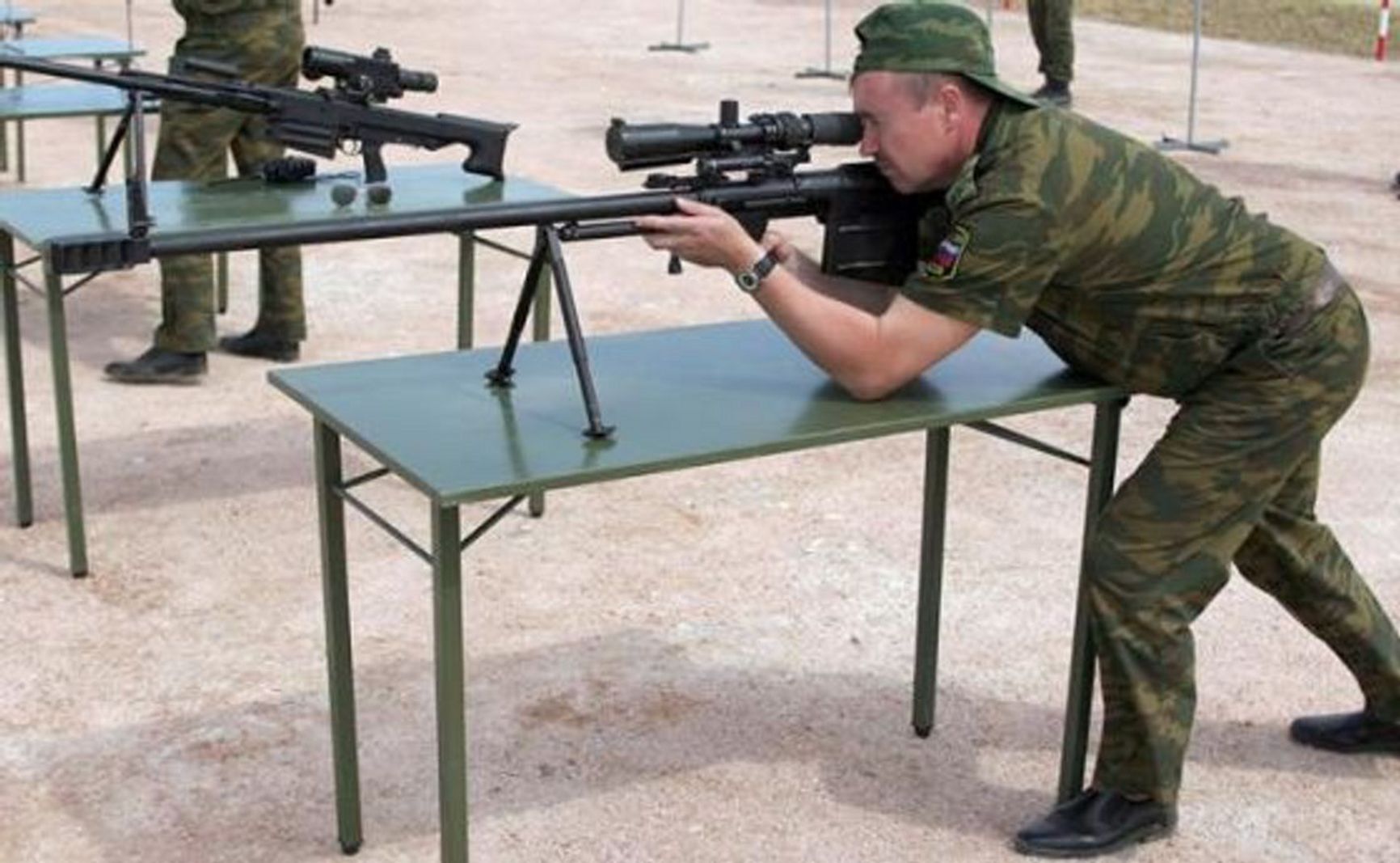 A Russian Ministry of Defense serviceman with an ASVK sniper rifle, notable for its size and barrel thickness.